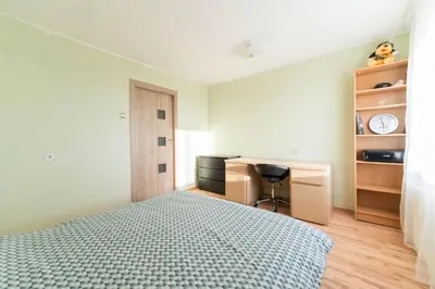 a bedroom with a bed and a desk and a chair at Šeškinės 61 Spacious Cozy Apartment in Vilnius