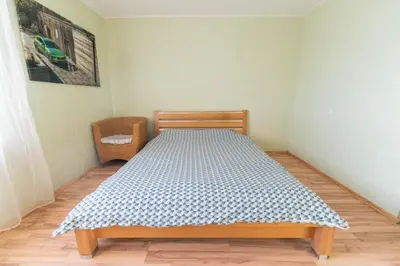 a bedroom with a bed in a room at Šeškinės 61 Spacious Cozy Apartment in Vilnius