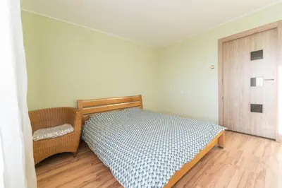 a small bedroom with a bed and a door at Šeškinės 61 Spacious Cozy Apartment in Vilnius