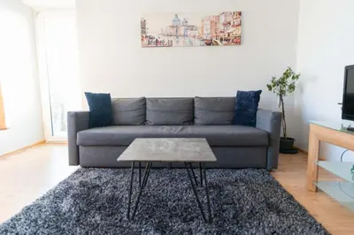 a living room with a couch and a coffee table at Šeškinės 61 Spacious Cozy Apartment in Vilnius