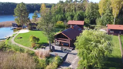 an aerial view of a house on a lake at Bebrusų sodyba in Molėtai