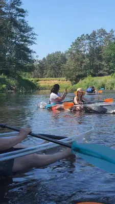 a group of people kayaking on a river at Kaimo turizmo sodyba Geras in Leliūnai