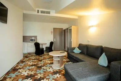 a living room with a couch and a table at Algiro Hotel in Kaunas