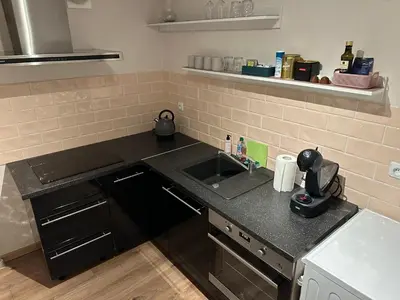 a kitchen with a sink and a counter top at Cozy Two Room Apartment near city centre in Alytus