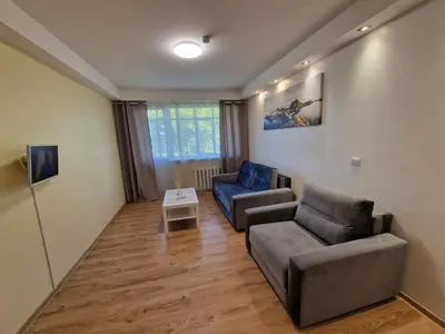 a living room with two chairs and a couch at Butas 34 in Šiauliai