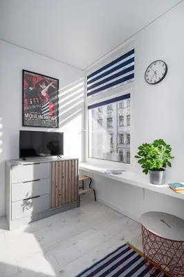 a living room with a television and a window at Studios K1A in Vilnius