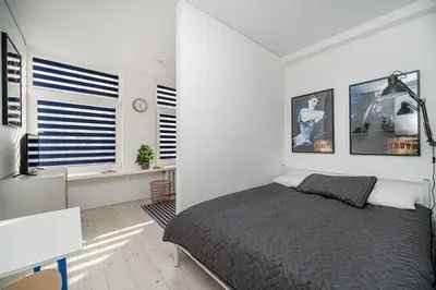 a bedroom with a bed and a desk and a window at Studios K1A in Vilnius