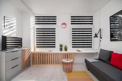 a living room with a couch and two windows at Studios K1A in Vilnius