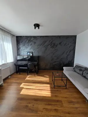 a living room with a piano and a couch at The cosiest apartment in Vilnius in Vilnius
