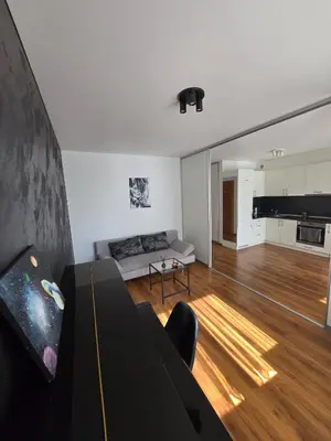 a living room with a couch and a table at The cosiest apartment in Vilnius in Vilnius