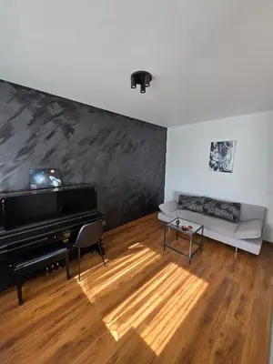 a living room with a piano and a couch at The cosiest apartment in Vilnius in Vilnius