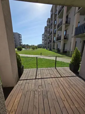 a wooden deck with a view of a building at The cosiest apartment in Vilnius in Vilnius