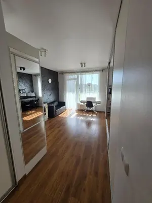 an empty living room with a table and a couch at The cosiest apartment in Vilnius in Vilnius