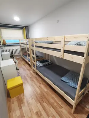a bedroom with bunk beds in a room at Tiki Taka Hostel & Pub in Vilnius