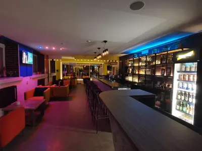 a bar with tables and chairs in a restaurant at Tiki Taka Hostel & Pub in Vilnius