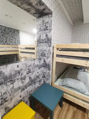 a small room with bunk beds and a bench at Tiki Taka Hostel & Pub in Vilnius