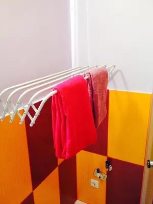 a bathroom with red towels hanging on a towel rack at A Cozy Central Studio in Druskininkai