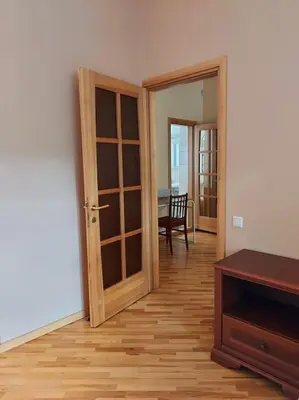 a room with a wooden door and a dining room at Cottage in old town in Vilnius