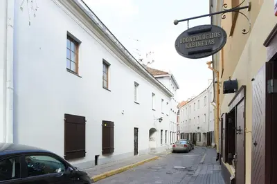 a street with a car parked on the side of a building at Cottage in old town in Vilnius