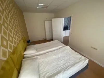 a bedroom with a large bed in a room at Perlos Apartamentai 3 in Birštonas