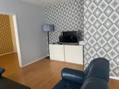 a living room with a couch and a tv at Perlos Apartamentai 3 in Birštonas