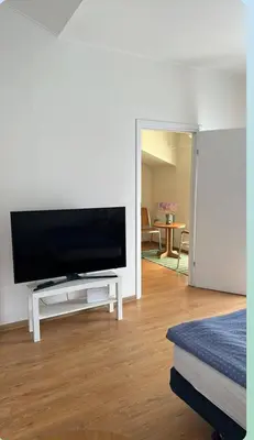 a living room with a flat screen tv on a table at Centro apartamentai in Birštonas