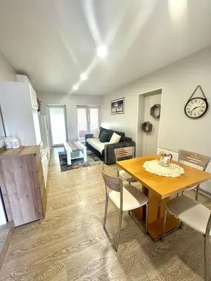 a living room with a table and a couch at Kaunas Stay Apartment in Kaunas