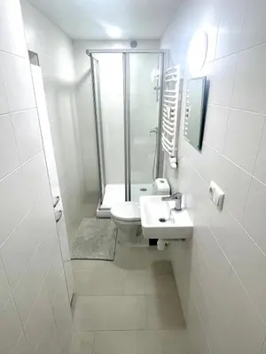 a bathroom with a shower and a toilet and a sink at Kaunas Stay Apartment in Kaunas