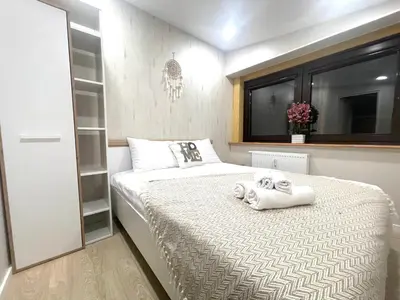 a bedroom with a bed with towels on it at Kaunas Stay Apartment in Kaunas