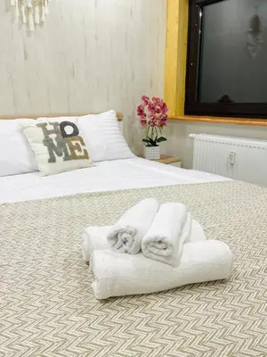 a bedroom with two white towels on a bed at Kaunas Stay Apartment in Kaunas