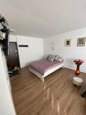 a bedroom with a bed and a wooden floor at Nice place to stay close to city in Kaunas