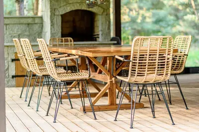 a wooden table and chairs on a patio at Ranča in Molėtai
