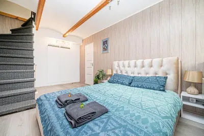 a bedroom with a bed with towels on it at Premium City Center Lukiskiu Apartment in Vilnius