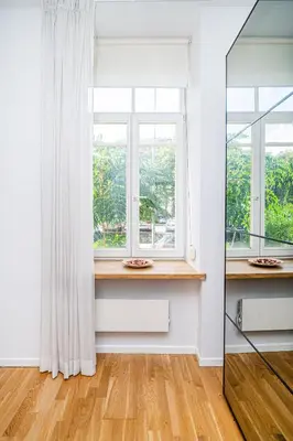 an empty room with a window and a wooden floor at Premium City Center Lukiskiu Apartment in Vilnius