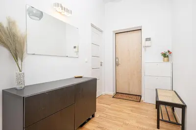 a living room with a black dresser and a door at Premium City Center Lukiskiu Apartment in Vilnius