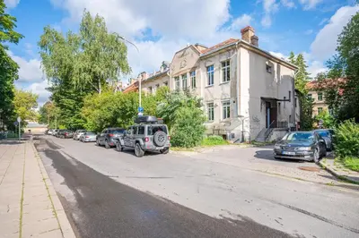 a street with cars parked on the side of the road at Premium City Center Lukiskiu Apartment in Vilnius