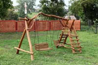 a wooden swing set in a yard at Liūto kalnas in Trakai