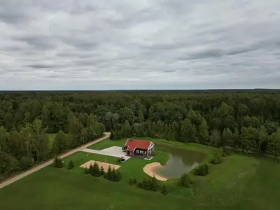 an aerial view of a house on a green field at Homestead Miško Vingis