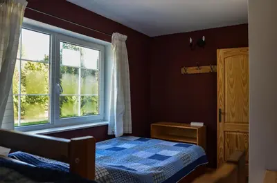 a bedroom with a bed and a window at Homestead Miško Vingis