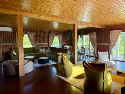 a large living room with couches and a table at Homestead Miško Vingis