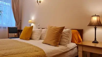 a bedroom with a bed with yellow pillows at Rehouse, Antokolskio 13 in Vilnius
