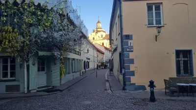 a narrow street with buildings and a building at Rehouse, Antokolskio 13 in Vilnius