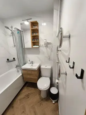 a bathroom with a toilet and a sink and a shower at Tukas Apartment in Marijampolė