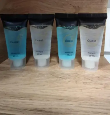 a group of four bottles of concealer on a table at Tukas Apartment in Marijampolė