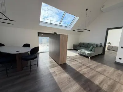 a living room with a table and a couch at Nemunas River View Apartment in Kaunas