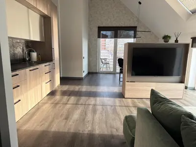 a living room with a large flat screen tv at Nemunas River View Apartment in Kaunas