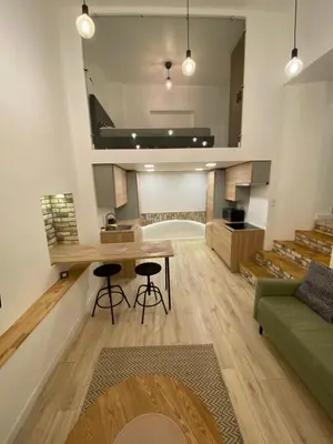 a living room with a table and a couch at Zema5 Old Town Loft in Vilnius