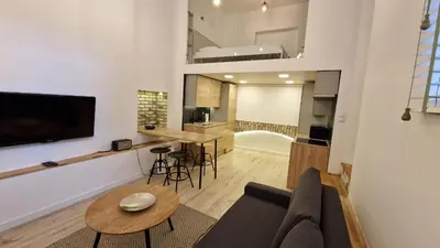 a living room with a couch and a table at Zema5 Old Town Loft in Vilnius