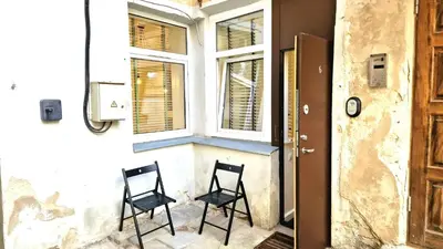 two black chairs sitting in front of a window at Zema5 Old Town Loft in Vilnius