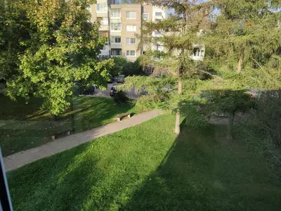 a view of a park with benches and a building at ShortStopPasilaiciai in Vilnius